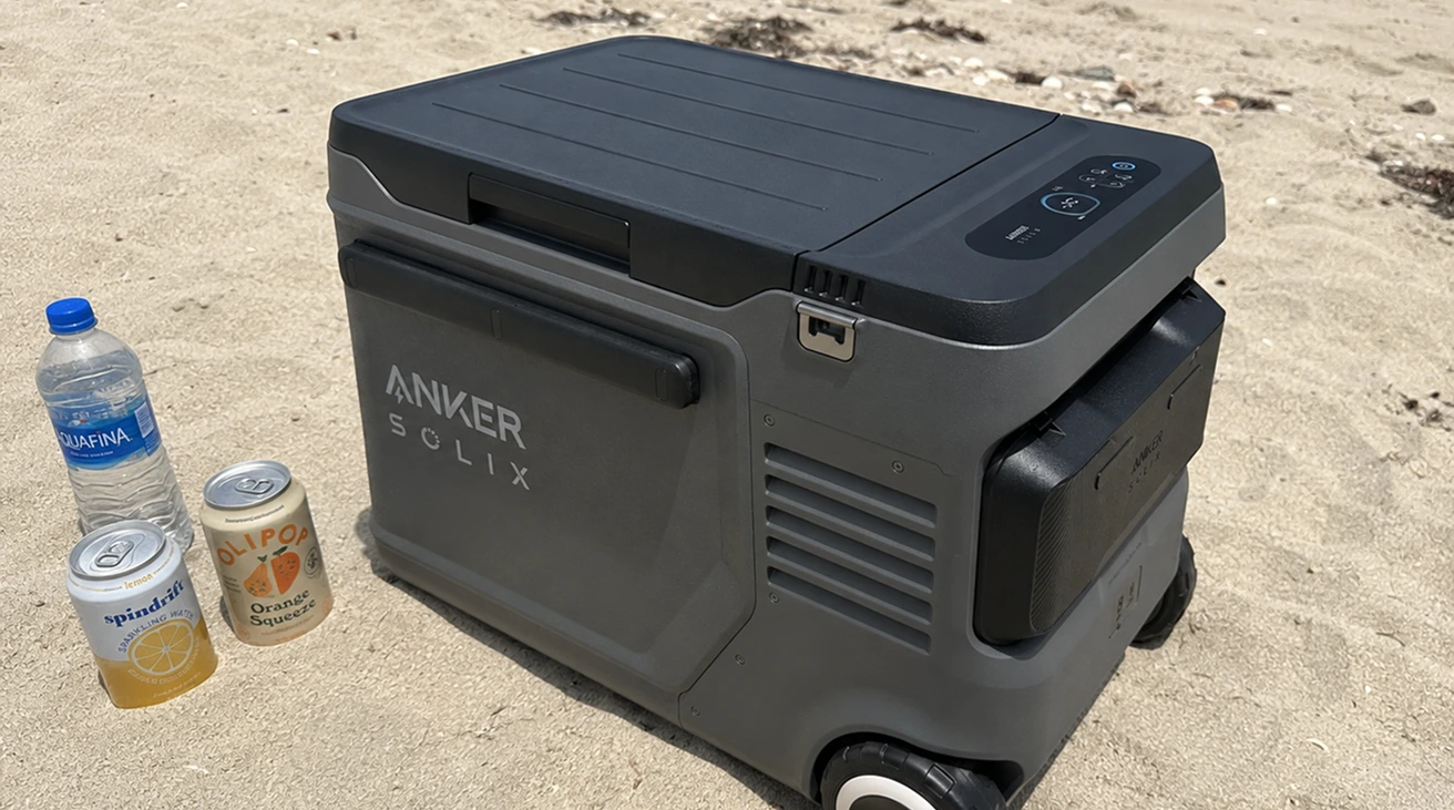 Power meter and battery display beside a 12V portable refrigerator in a vehicle setup