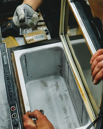 A portable fridge being checked during use