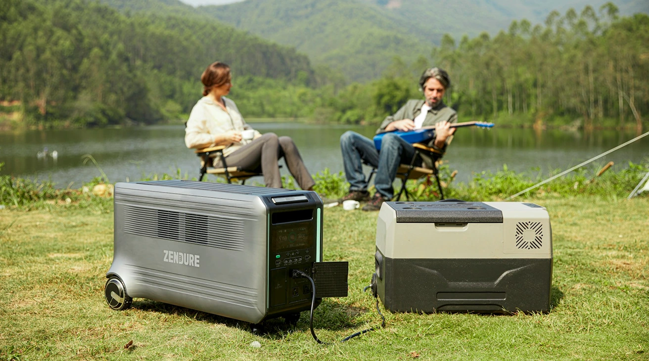 A traveler loading a vehicle beside a portable electric cooler